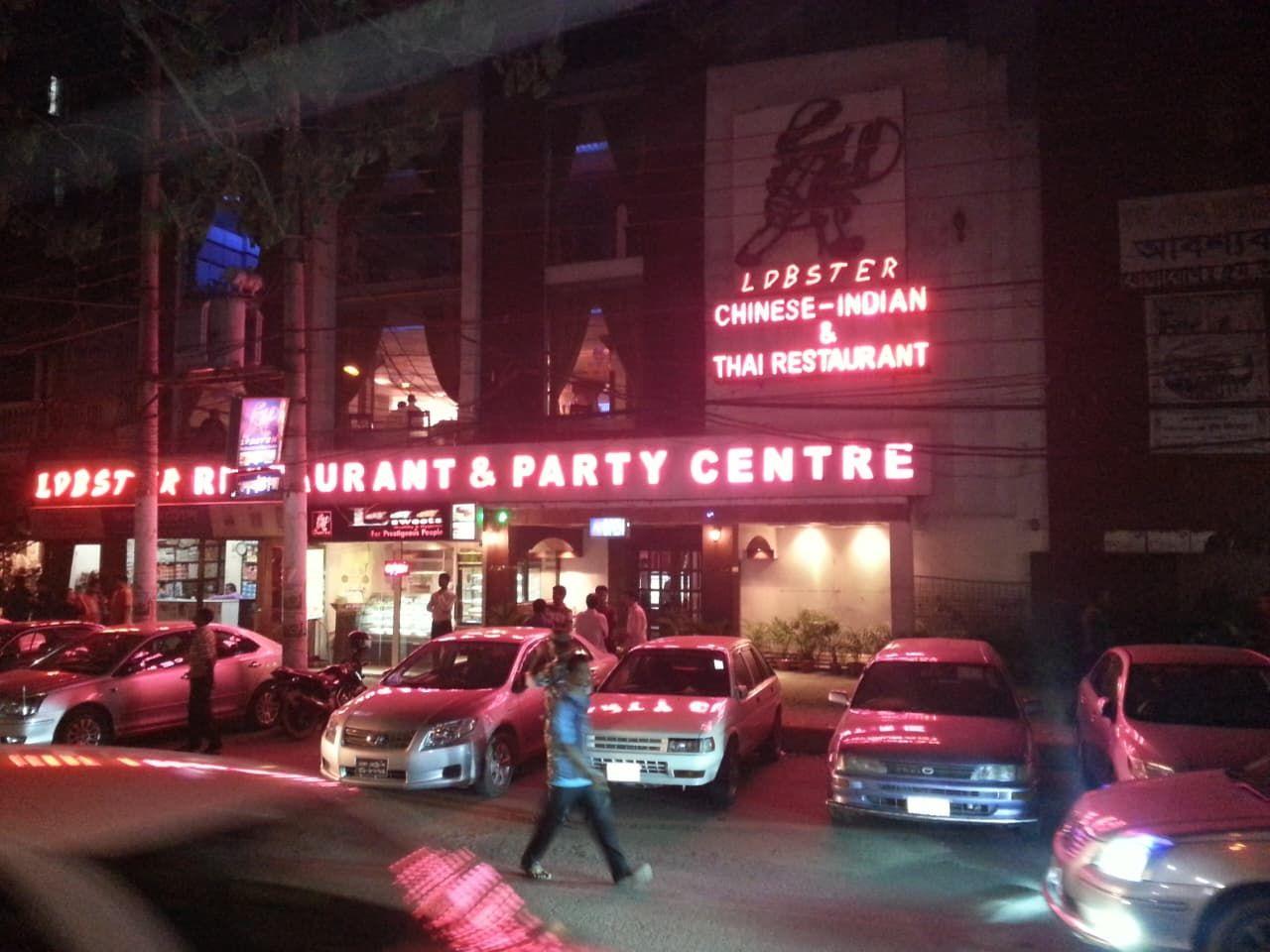 Lobster Restaurant & Party Centre at night, with its neon sign lit above the street