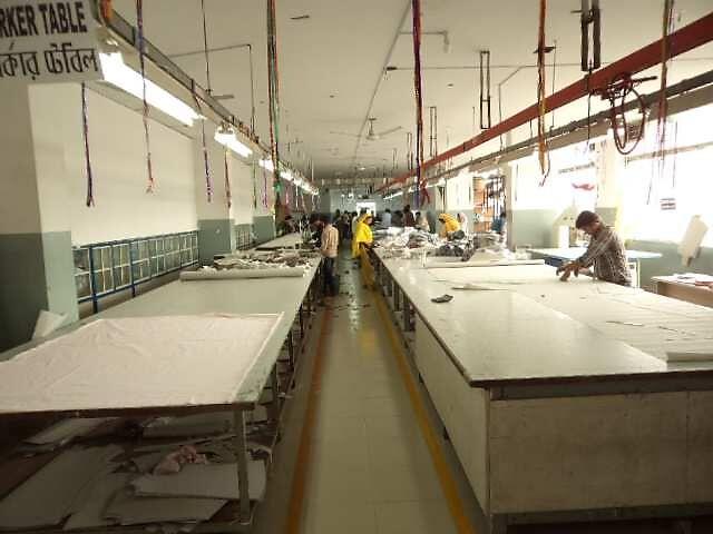 Long white cutting tables in the cutting section