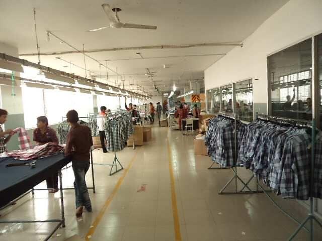 Finishing section with garments on rails and inspection tables